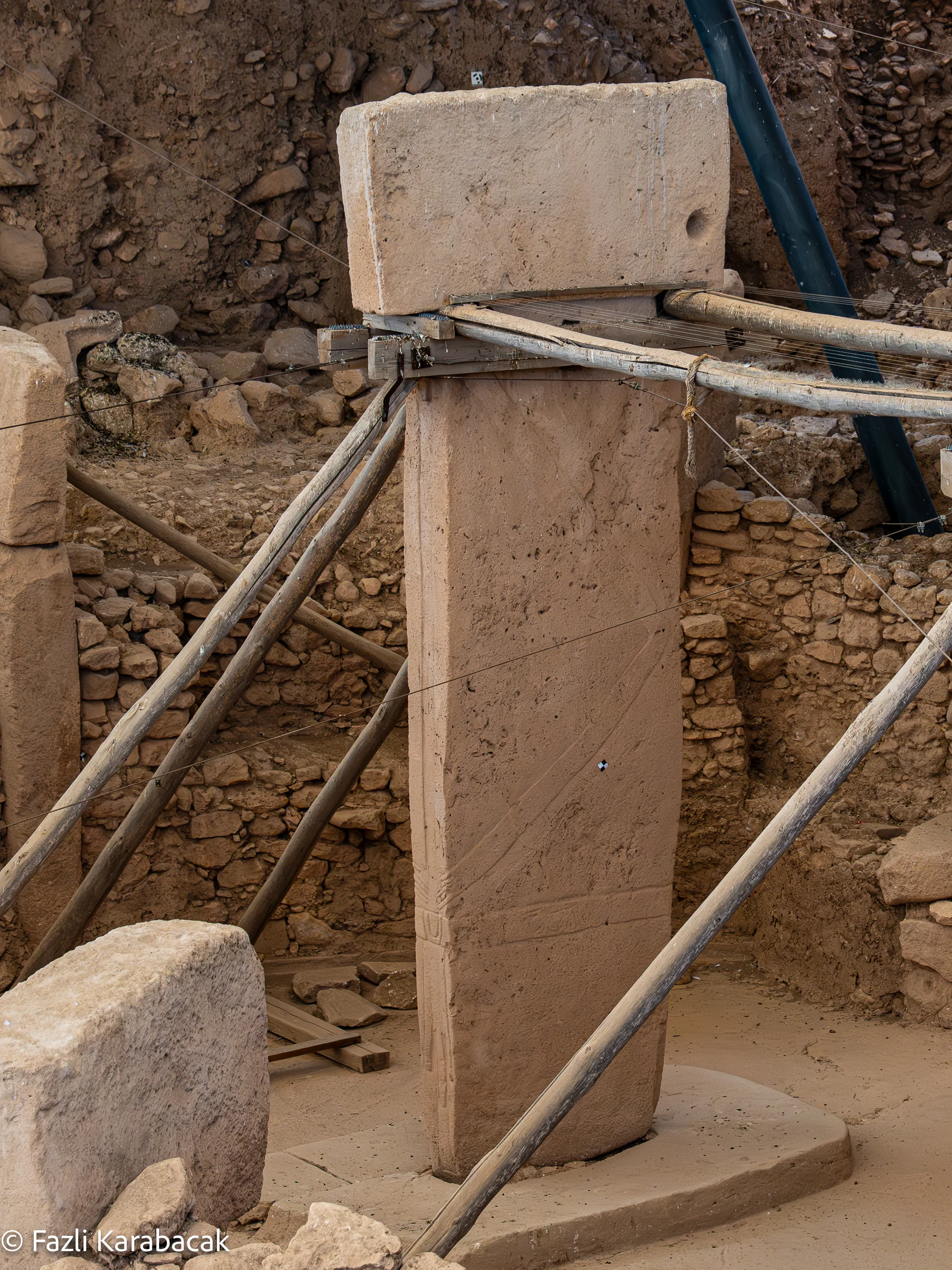 Central Pillar 18 of Enclosure D, bearing carved arms, belt, and loincloth — a classic example of Eliade's axis mundi