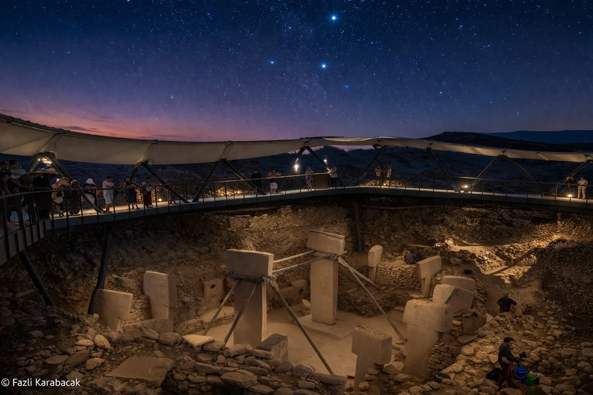 Night sky with bright stars above the silhouette of Göbekli Tepe excavation site
